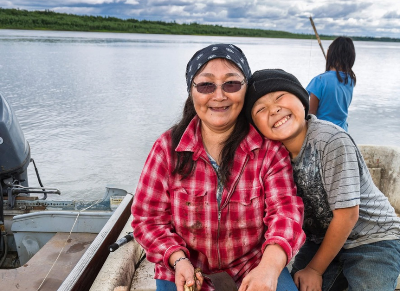 Woman and her children fishing on a boat